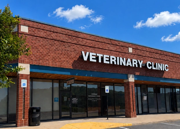 Exterior of a brick veterinary clinic storefront with "Veterinary Clinic" signage