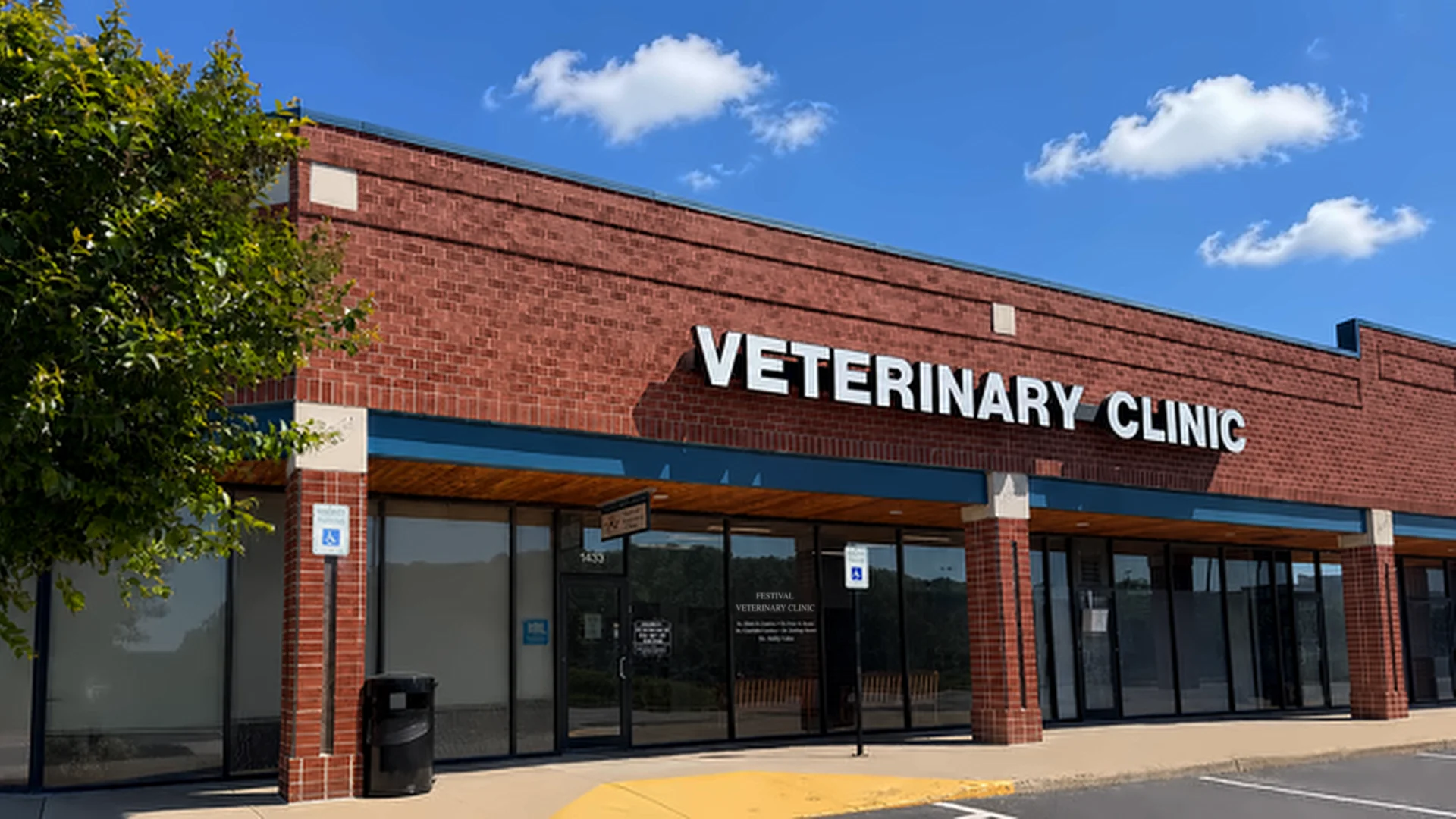 Exterior of a brick veterinary clinic storefront with "Veterinary Clinic" signage